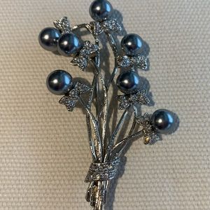 A beautiful rhinestone gray faux pearl floral bouquet pin brooch
